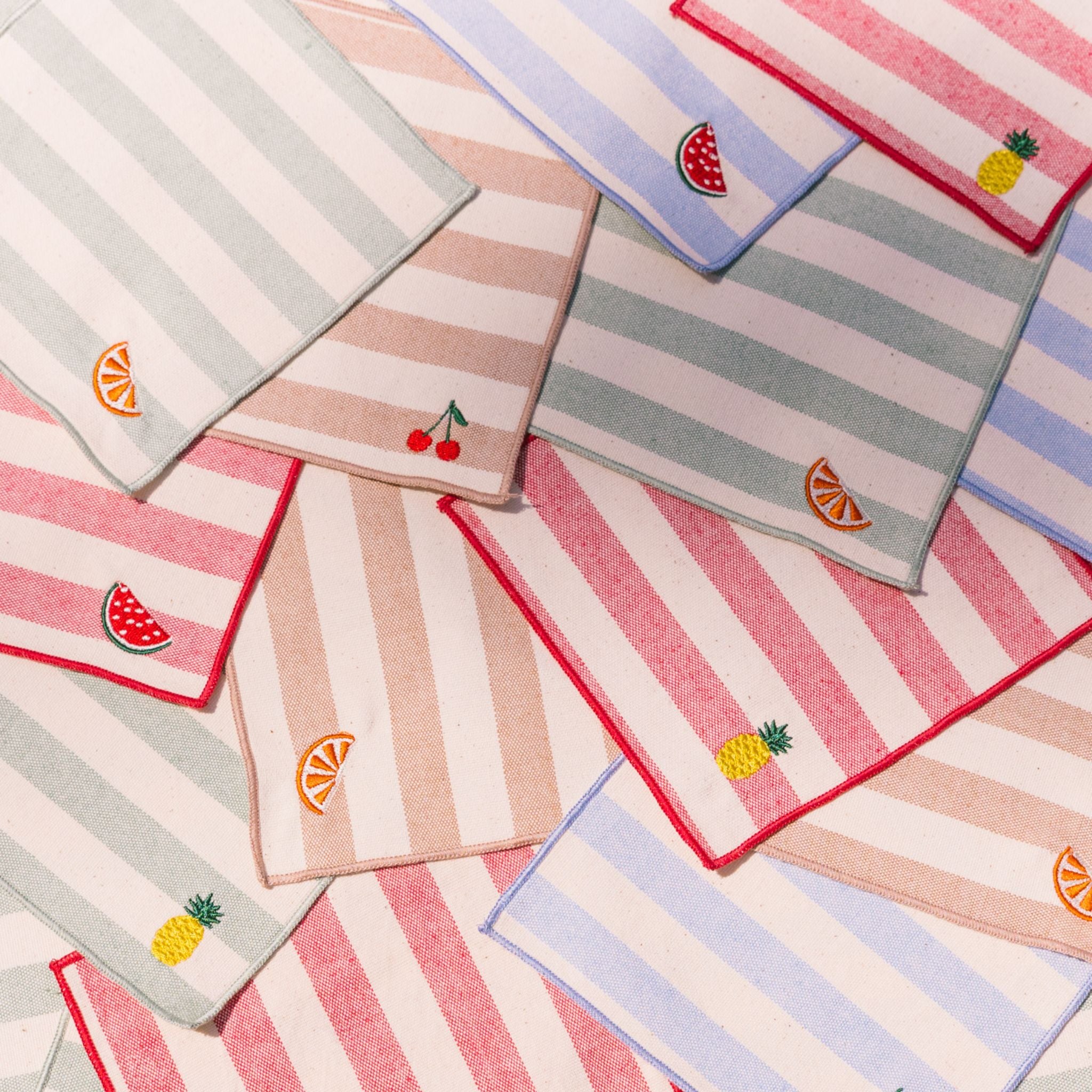 Collection of striped cocktail napkins with fruits: pineapple, cherry, watermelon and orange embroidery.
